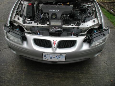 2002 Pontiac Grand Prix - Front view of a silver 2002 Pontiac Grand Prix with the hood open, revealing the engine and front end components.