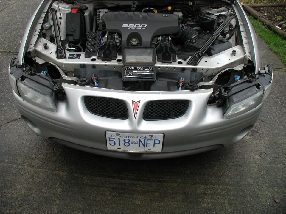 Silver 2002 Pontiac Grand Prix front view, hood open, showing engine and front grille