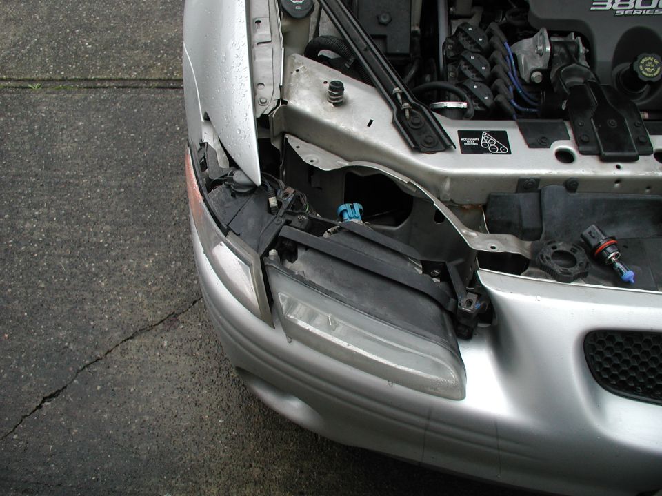 2002 Pontiac Grand Prix front fender and headlight assembly with engine visible