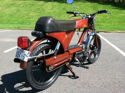 1981 Garelli Rally Sport - Red Garelli moped parked on asphalt with a grassy background.