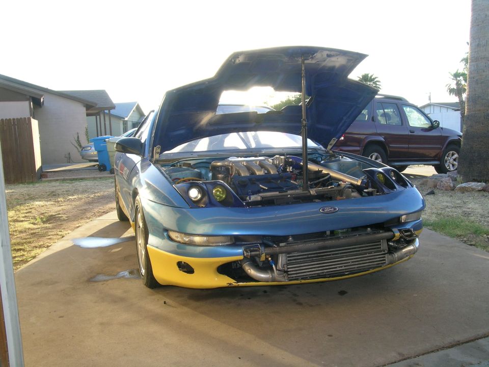 1995 Ford Probe with hood open, showing engine and aftermarket intercooler. Yellow front bumper accents