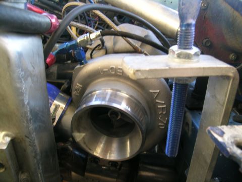 1995 Ford Probe - Close-up of a turbocharger, identified by markings "JR70" and "1-05", within a complex engine bay.
