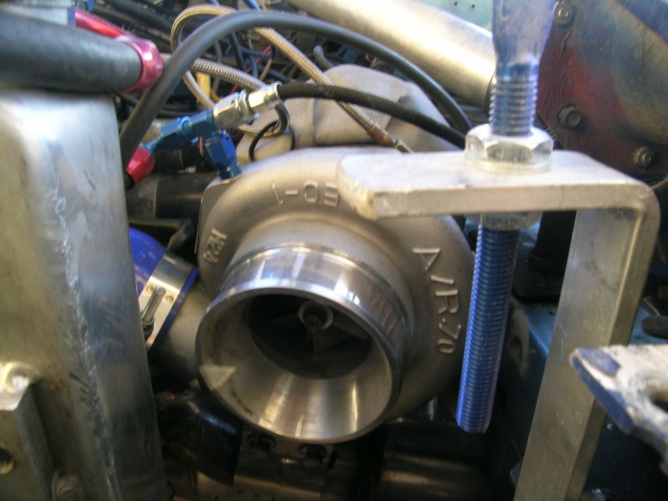 Turbocharger with "JR70" and "1-05" markings, part of engine bay