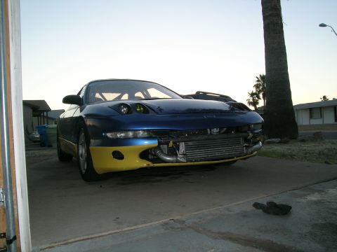 1995 Ford Probe - Modified sports car with custom front end modifications and two-tone paint scheme.