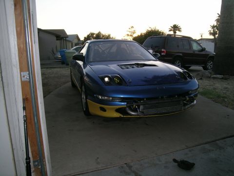 1995 Ford Probe - Modified 1995 Ford Probe in driveway with an SUV behind it.