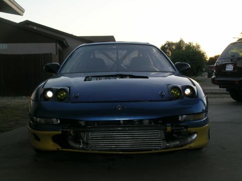 1995 Ford Probe - This modified Ford Probe features a prominent intercooler and a visible roll cage, suggesting performance upgrades.