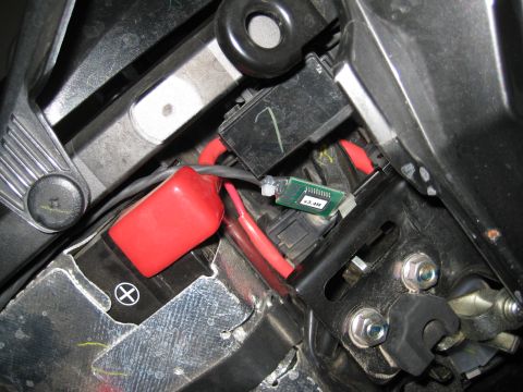 2008 Yamaha FZR1000 - Close-up view of a motorcycle's battery and wiring harness, including a small green circuit board.