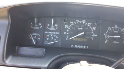 1994 Ford Bronco - Dashboard gauges for a 1994 Ford Bronco, displaying speedometer, tachometer, fuel level, and engine temperature readings.