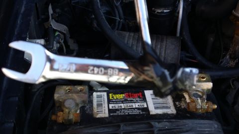 1994 Ford Bronco - A wrench rests on an EverStart battery in the engine bay of a vehicle.