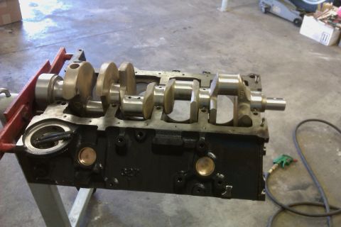 1996 Chevrolet Camaro - Engine block and crankshaft assembly on a stand in a workshop setting.