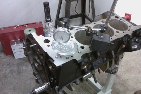 1996 Chevrolet Camaro - Engine block being measured with a dial indicator, likely for machining or inspection.