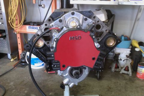 1996 Chevrolet Camaro - Engine block with a red MSD distributor cap and black spark plug wires is mounted on a stand.