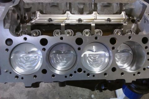 1996 Chevrolet Camaro - Close-up view of an engine block's cylinder bores and pistons, showing internal engine components.