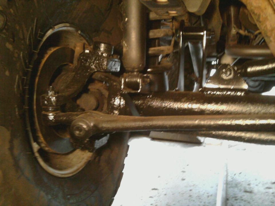 Undercarriage of a vehicle with greasy suspension components and a tire