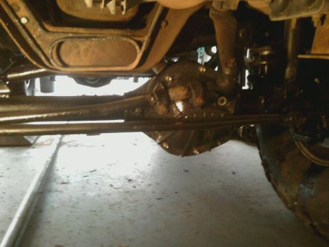 1996 Ford Bronco - Close-up view of the undercarriage, focusing on the differential and suspension system of an unidentified vehicle.