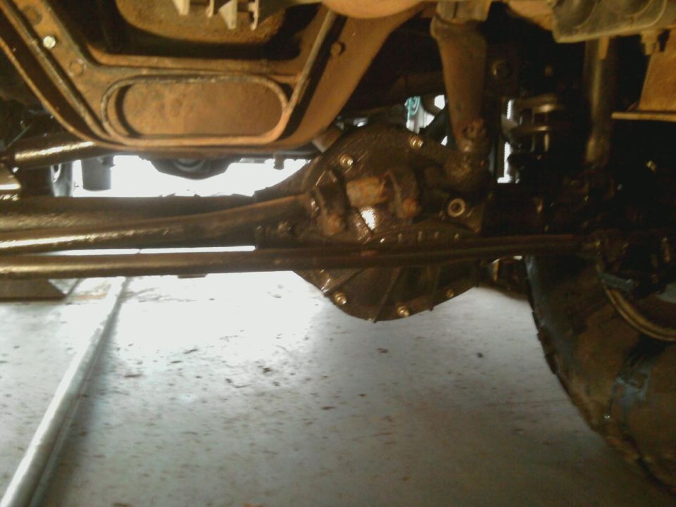 Undercarriage view of a vehicle's differential and suspension components