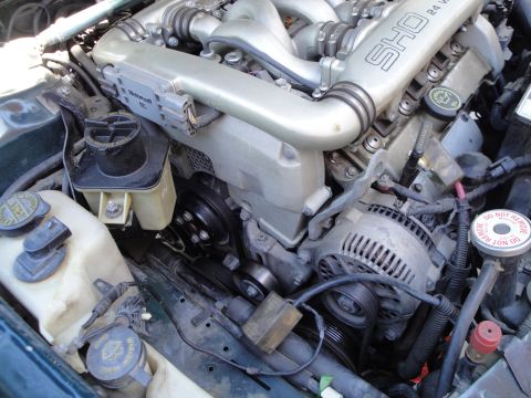 1995 Ford Taurus - The engine compartment displays a Ford SHO 24-valve V6 engine, with visible components like the alternator and intake manifold.