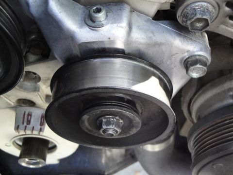 1995 Ford Taurus - Engine pulley system detail, showing a belt tensioner and mounting bracket.