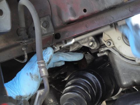 1995 Ford Taurus - Close-up of automotive repair work being performed on engine parts.