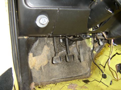 1979 Ford Mustang - Interior view of a car's footwell, focusing on the pedals and floor area.