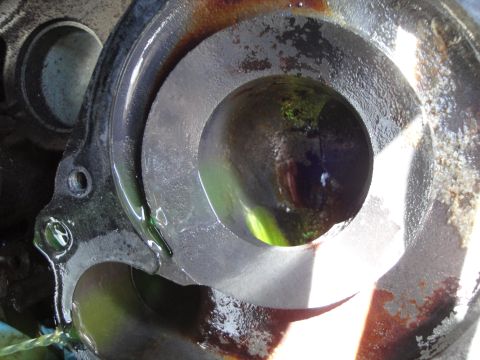 1995 Ford Taurus - A close-up view of a mechanical engine part, showing fluid accumulation within its structure.