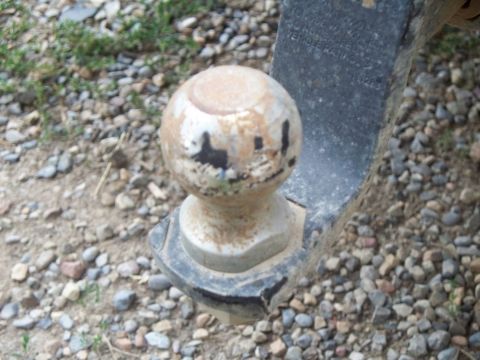 1992 Ford F-250 - Close-up of a trailer hitch ball, showing wear and tear on the metal surface.