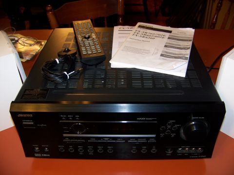 1992 Jeep YJ - An Onkyo AV receiver, remote control, and instruction manuals are displayed on a table.