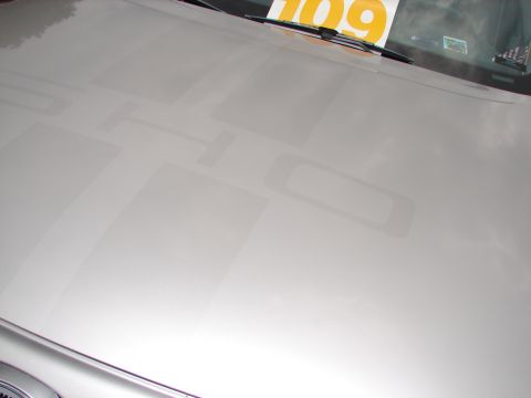 1992 Ford Taurus - Faded "SHO" graphics are visible on the hood of a silver car.