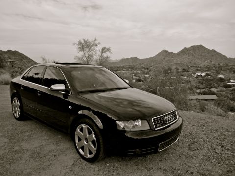 2005 Audi S4 - A black 2005 Audi S4 sedan is parked on a dusty hillside, overlooking a valley with mountains in the distance.