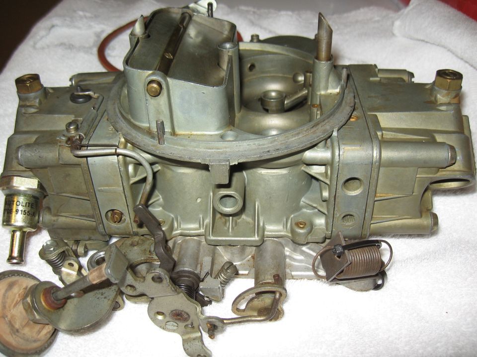 Holley carburetor with Autolite sensor and visible linkage, viewed from the front
