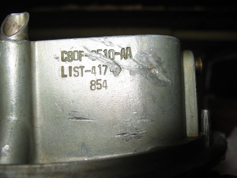 1968 Shelby GT500 - Close-up of a Holley carburetor part showing stamped identification numbers.