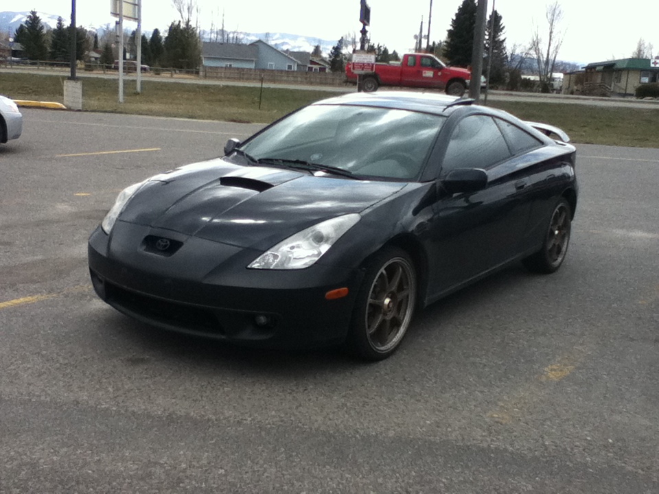 Black Toyota Celica parked in a lot, front 3/4 view