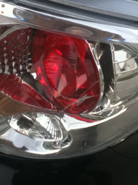 2006 Ford E350 - Close-up of a cracked red and clear taillight assembly on a vehicle.