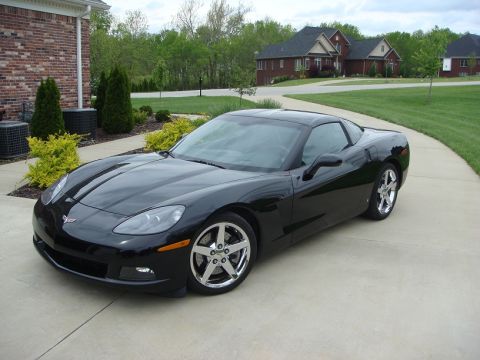 2006 Chevrolet Corvette - A black 2006 Chevrolet Corvette is parked on a driveway with a house in the background.