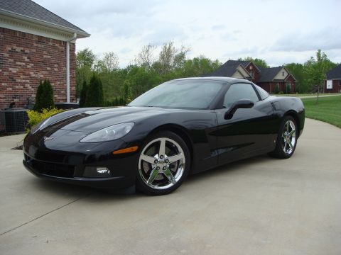 2006 Chevrolet Corvette - A black Chevrolet Corvette is parked in a suburban driveway.