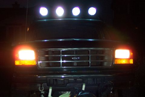 1995 Ford Bronco - Front view of a 1995 Ford Bronco at night, equipped with a light bar.