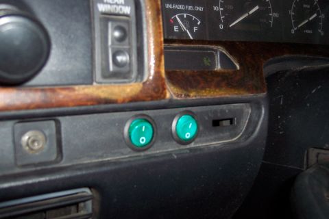 1995 Ford Bronco - Close-up of a vehicle's dashboard interior, showing gauges and toggle switches.