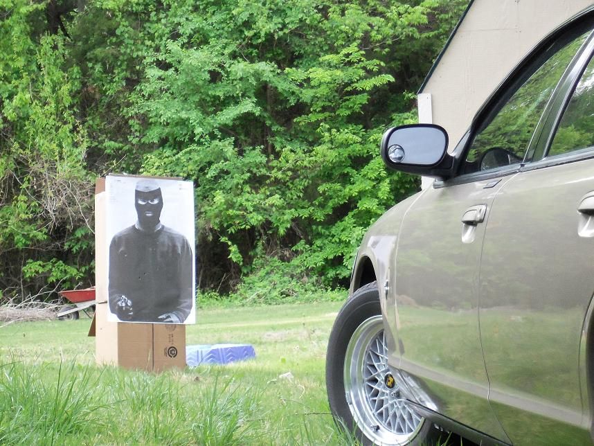 Tan car side view with target practice dummy