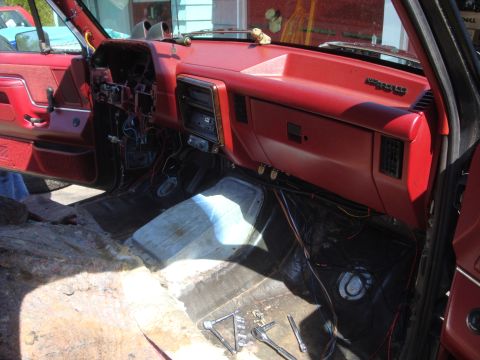 1989 Ford Bronco - Interior view of a 1989 Ford Bronco undergoing extensive work, with the dashboard and carpeting removed.