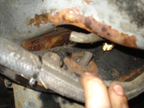 1989 Ford F-250 - Close-up view of a rusted suspension component, likely a bracket or mounting point.