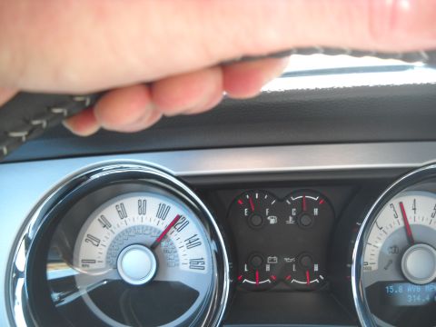 2012 Ford Mustang - The speedometer shows the car is traveling at a high speed, indicated by the needle near 120 mph.
