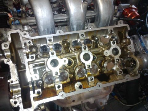 1995 Ford Probe - The internal components of an engine's valve cover are exposed, showing the valves and lubrication.