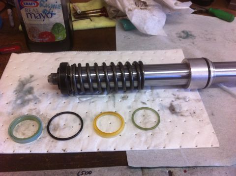 Suzuki Samurai - A disassembled shock absorber and its seals are laid out on a mat, with a bottle of mayonnaise visible in the background.