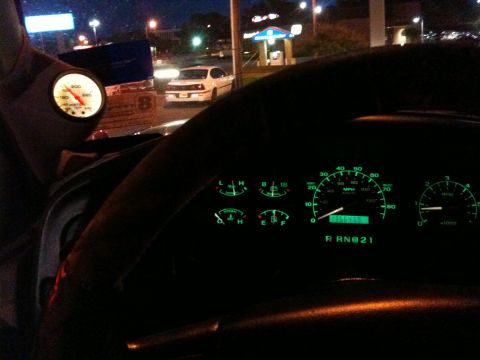 1996 Ford Bronco - The dashboard of a vehicle displays illuminated gauges and a digital odometer showing 055575 miles.