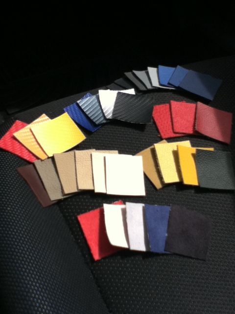 2006 Ford E350 - Multiple fabric and leather swatches are displayed on a car seat, likely for interior trim selection.