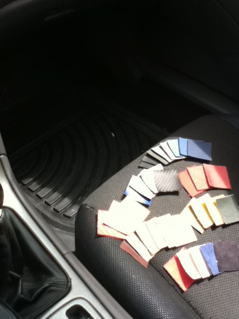 2006 Ford E350 - Various material swatches are arranged on the textured seat of a vehicle.