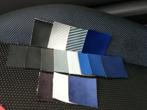 2006 Ford E350 - A collection of interior material samples is displayed on a vehicle seat.