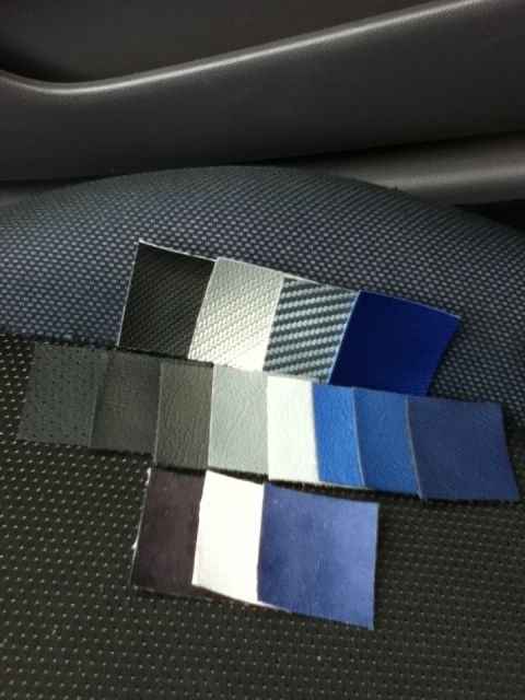 2006 Ford E350 - Multiple fabric swatches are displayed on a textured surface, showing different colors and textures for interior trim options.