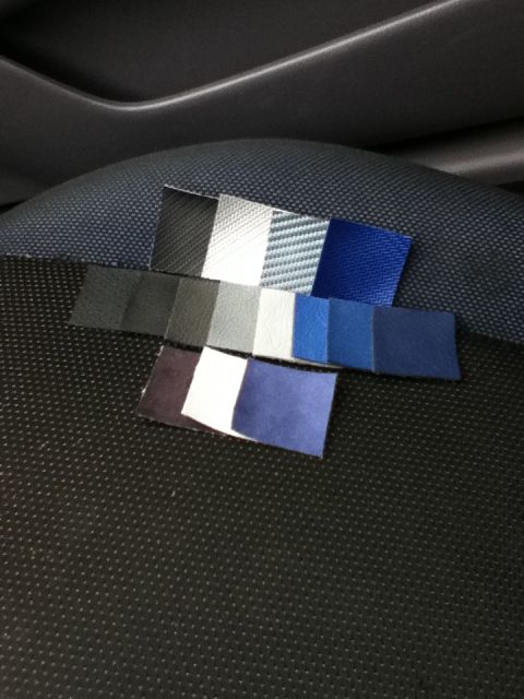 2006 Ford E350 - Various fabric and leather samples are displayed on the textured seat of a vehicle's interior.