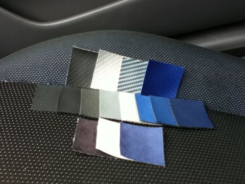 2006 Ford E350 - A collection of fabric swatches is laid out on a textured seat, displaying different colors and patterns.